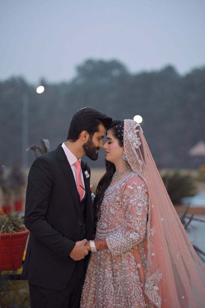 Romantic outdoor portrait of a Pakistani bride and groom captured by Shahzaib Studios, wedding photographer in Islamabad, Rawalpindi, and Wah Cantt.