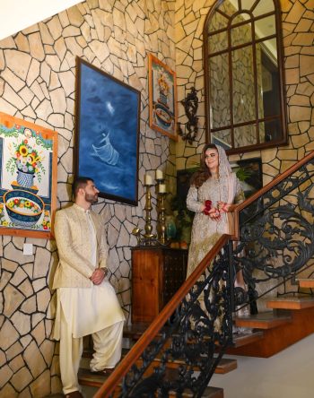 A beautifully composed wedding portrait of the bride and groom on a grand staircase, showcasing elegant architecture and timeless storytelling by Shahzaib Studios. Creative bride and groom portrait on an elegant staircase captured by Shahzaib Studios, wedding photographer in Islamabad, Rawalpindi, and Wah Cantt.