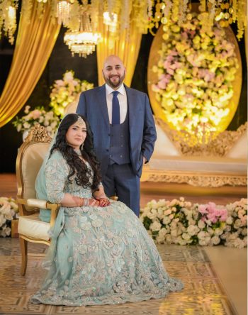 A timeless wedding stage portrait showcasing the bride and groom surrounded by elegant floral décor and warm lighting, professionally captured by Shahzaib Studios. Elegant bride and groom wedding stage portrait captured by Shahzaib Studios, professional wedding photographer in Islamabad, Rawalpindi, and Wah Cantt.