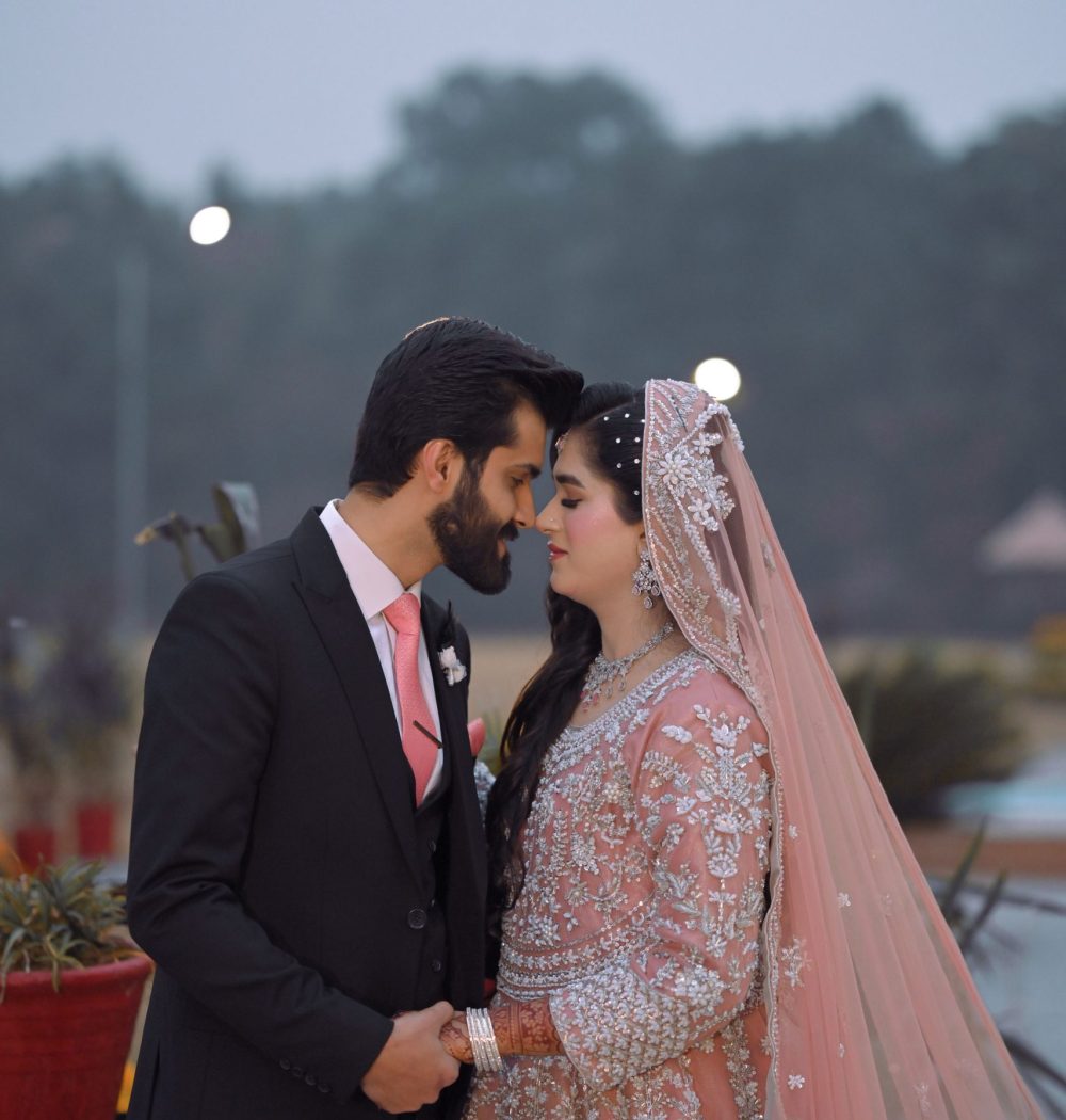 Romantic outdoor portrait of a Pakistani bride and groom captured by Shahzaib Studios, wedding photographer in Islamabad, Rawalpindi, and Wah Cantt.
